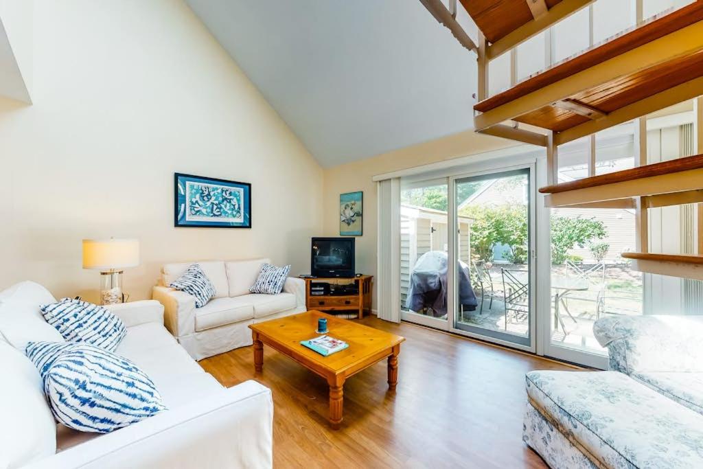 a living room with a white couch and a table at Relaxing Cape Getaway in Brewster