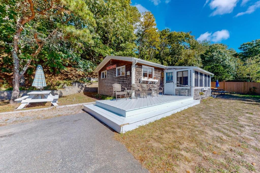a tiny house with a deck and a bench at Villa Fairview in South Dennis