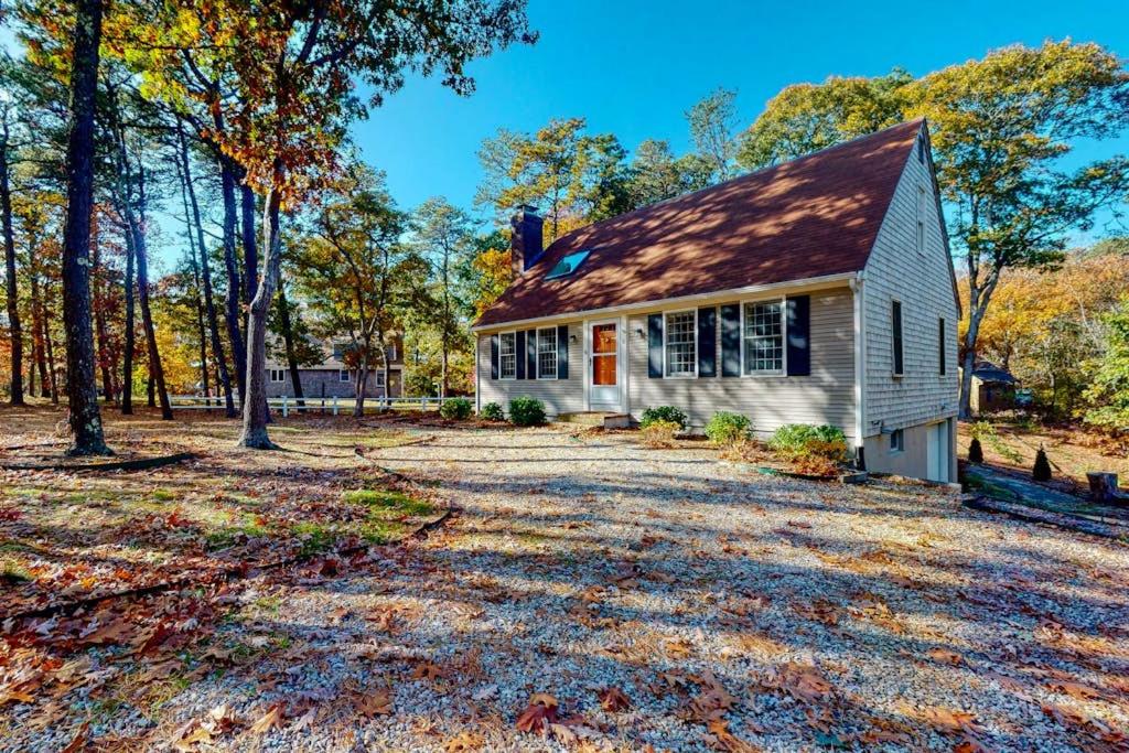 a white house with a gambrel roof at Sit Back & Relax in Eastham