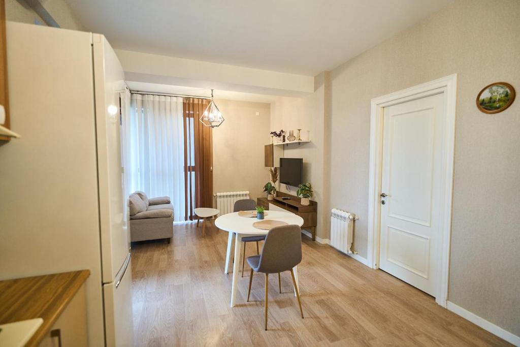 a living room with a table and chairs in a room at Baku Sabah Apart in Baku