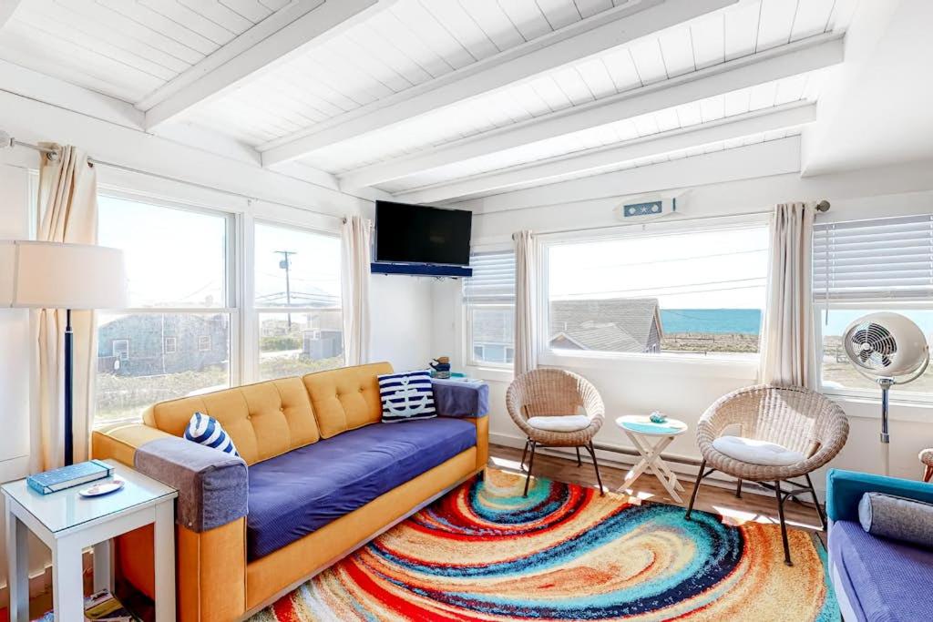 a living room with a couch and a table at Dunes Edge in Wellfleet