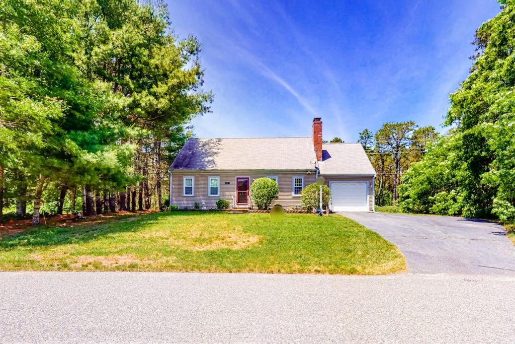a large white house with a driveway at Mattakeese Villa in Yarmouth