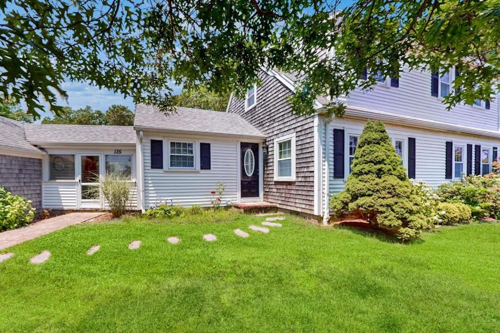 a white house with a tree in the yard at Ocean Bird Nest in South Yarmouth