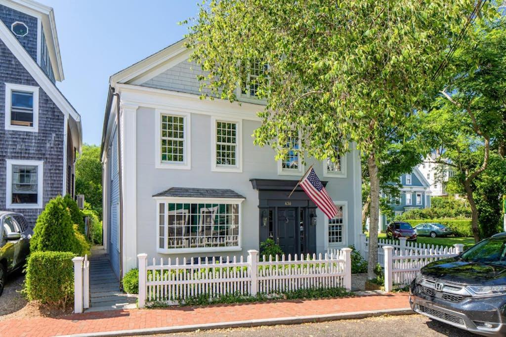 a white fence in front of a house at The Long Fox in Provincetown