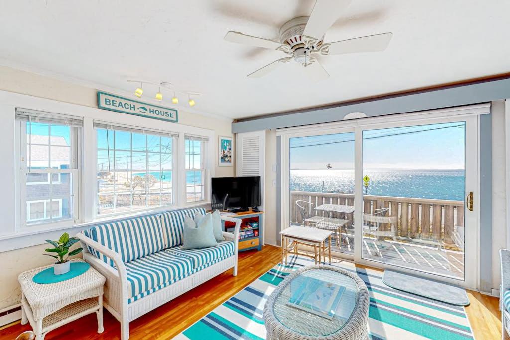 a living room with a couch and a view of the ocean at Bay Colony Vista in Provincetown