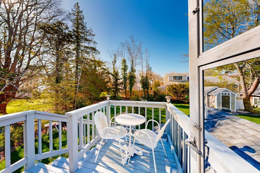 a white porch with a table and chairs on it at Everyday is Saturday in Vineyard Haven