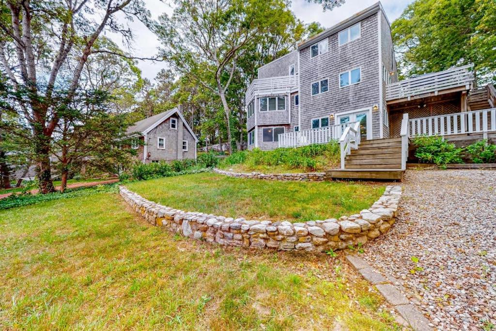 a house with a stone wall in front of a yard at Lake Elizabeth Terrace in Centerville