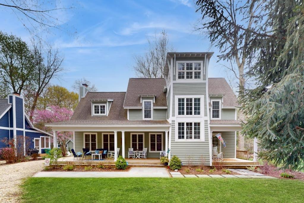 a large white house with a porch at Seaglass Lakeshore Cottage in Union Pier