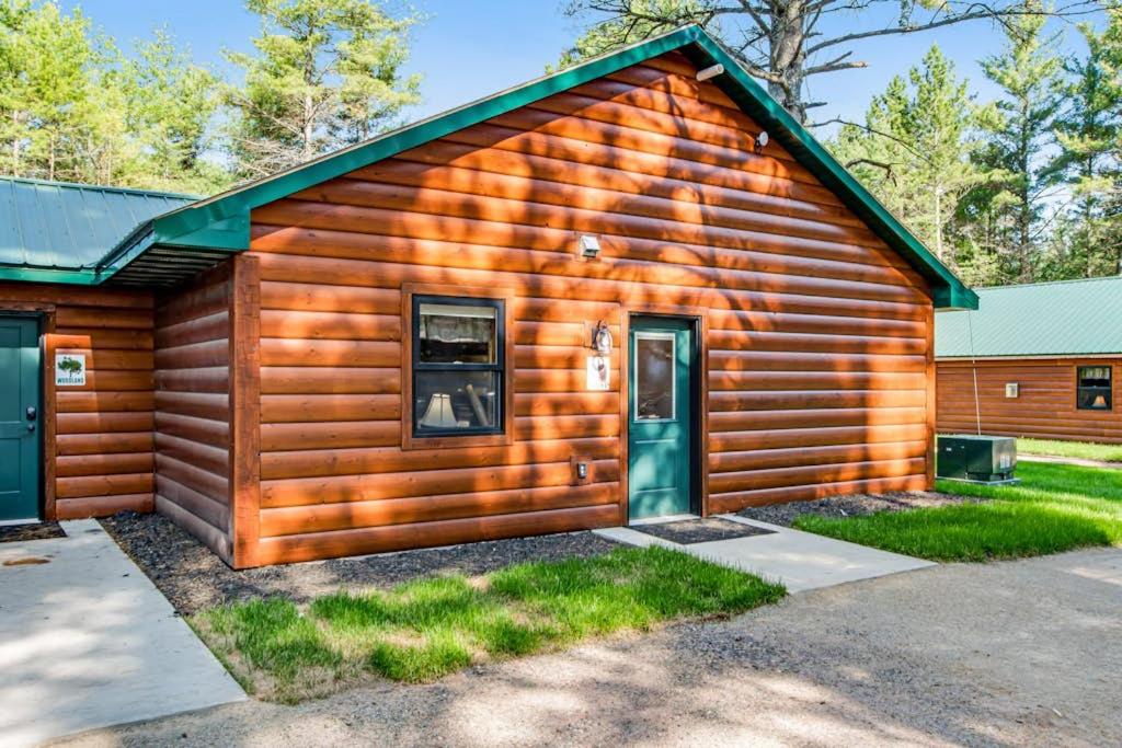 a log cabin with a green door at The Eagle in Conover