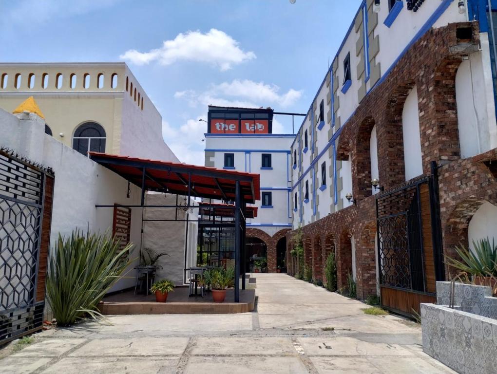 a building with a red awning on a street at Hotel CHOLOA in Cholula