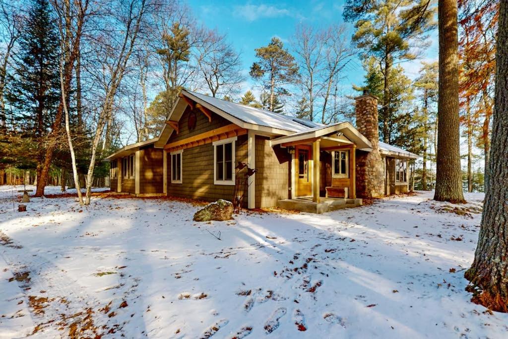 a cabin in the woods in the snow at Moon Ridge Lodge in Saint Germain