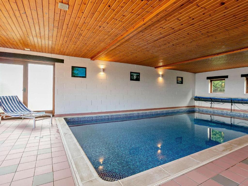 a swimming pool in a house with a wooden ceiling at 2 Bed in Holmfirth oc-emley in New Mills