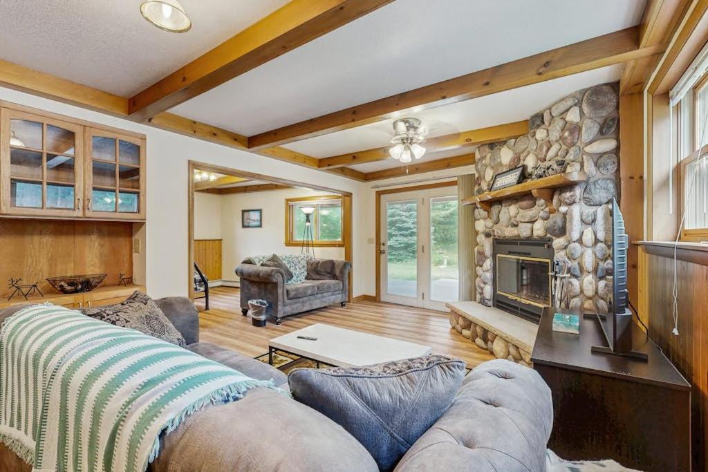 a living room with a couch and a fireplace at Rustic Woodland Retreat- Unit A in Arkdale