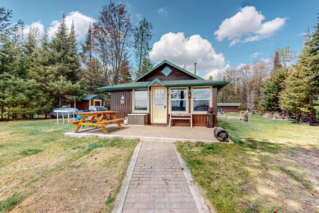 a small cabin in a field with a picnic table at The View on Found Lake in Saint Germain