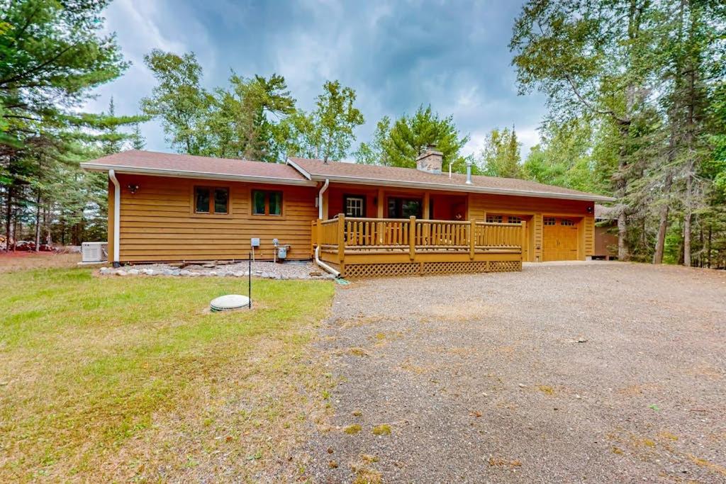 a log home with a large yard in front of it at Konkey's Kabin in Saint Germain