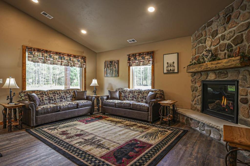 a living room with two couches and a fireplace at The Beaver in Conover