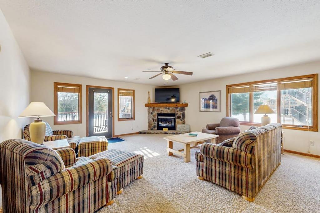 a living room with two couches and a fireplace at Sunset Condominiums: Golf View in Arkdale