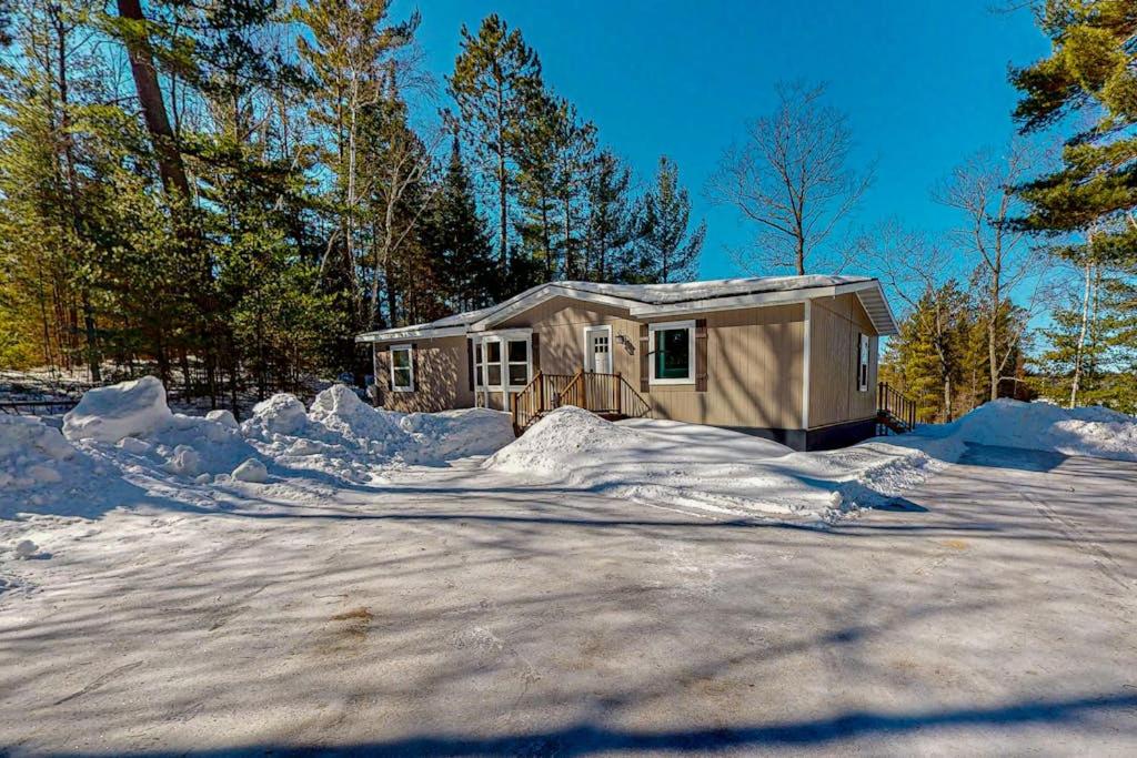 a small house in the middle of a lot of snow at Thoro Cottage in Minocqua