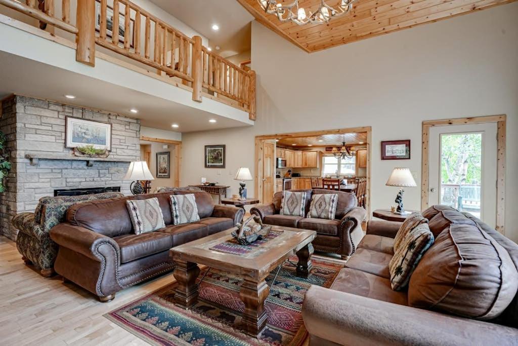 a living room with leather furniture and a fireplace at Island View I in Eagle River