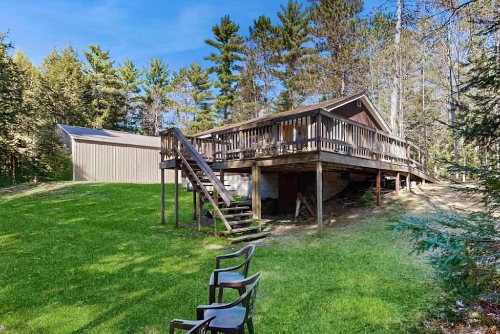 a large house with a deck on a lawn at Quaint Lake Escape in Eagle River