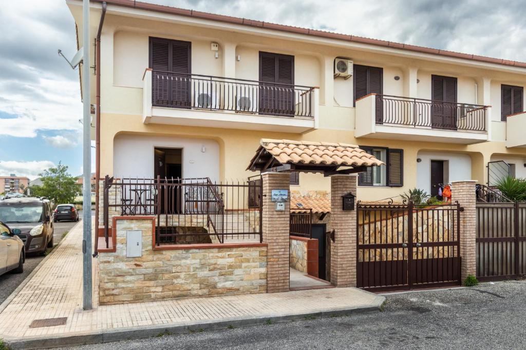 a house with a balcony and a gate at Casa Amica in Avola