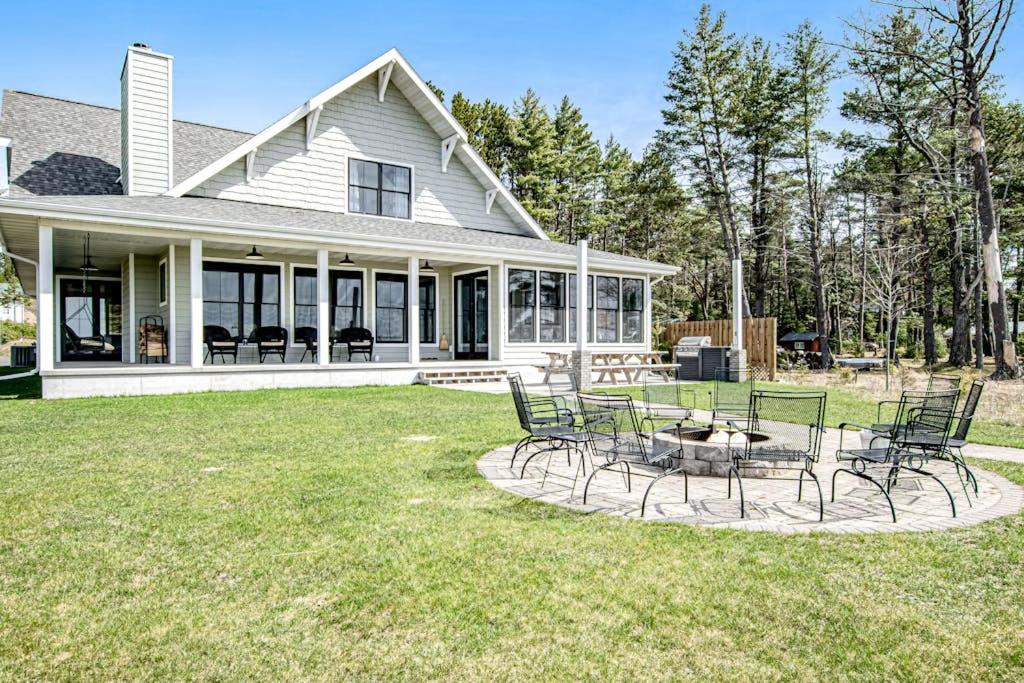 a house with chairs and a table in the yard at Summer Breeze in Sayner