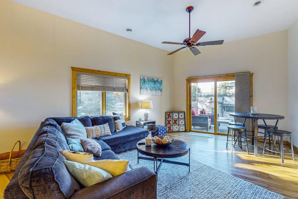 a living room with a blue couch and a table at Lake Minocqua Lakeview in Minocqua