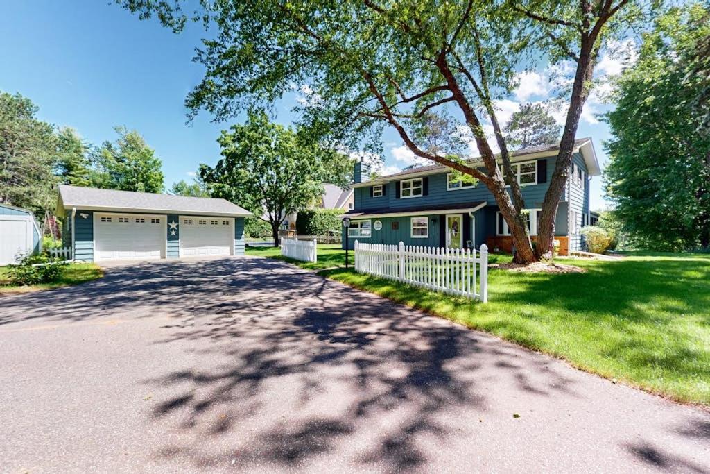 a house with a tree and a driveway at Turtle Bay in Minocqua