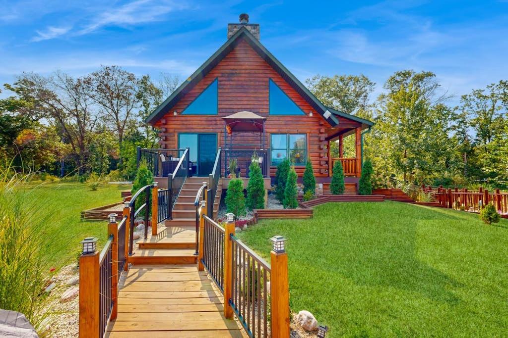 a home with a wooden walkway leading to a house at Blissful Deer Cabin in Friendship