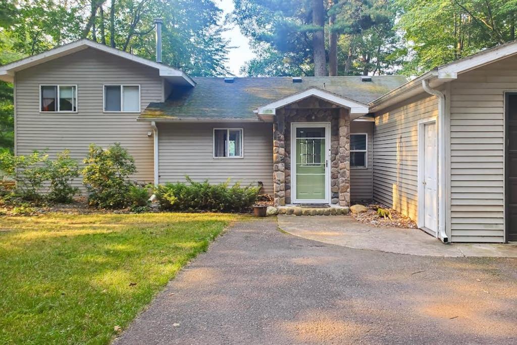 a house with a green door in a yard at Tall Pines in Woodruff