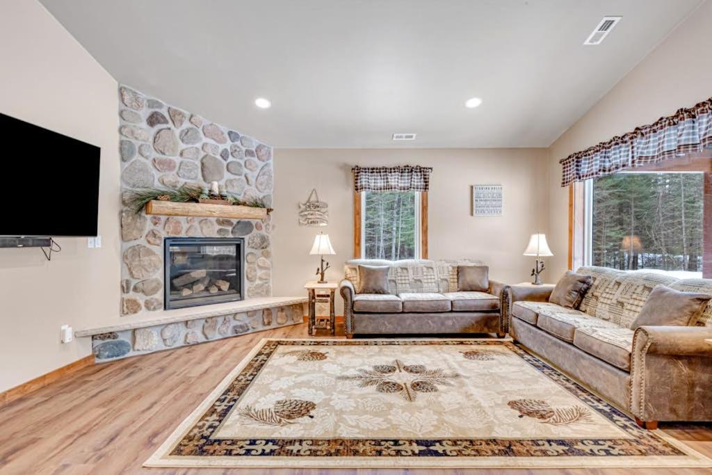 a living room with a couch and a fireplace at The Fish in Conover
