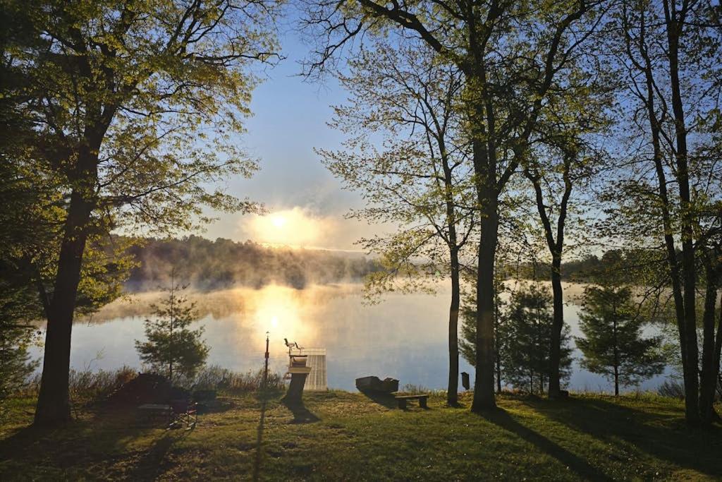 a view of a lake with the sun reflecting on the water at Hooked on Johnson in Arbor Vitae