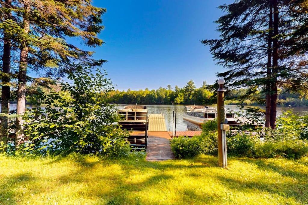 a wooden dock with a boat on a lake at The Honeymoon in Mercer