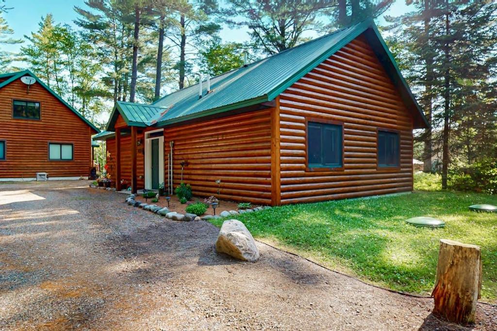 a cabin in the woods with a gravel driveway at The Aspen in Mercer