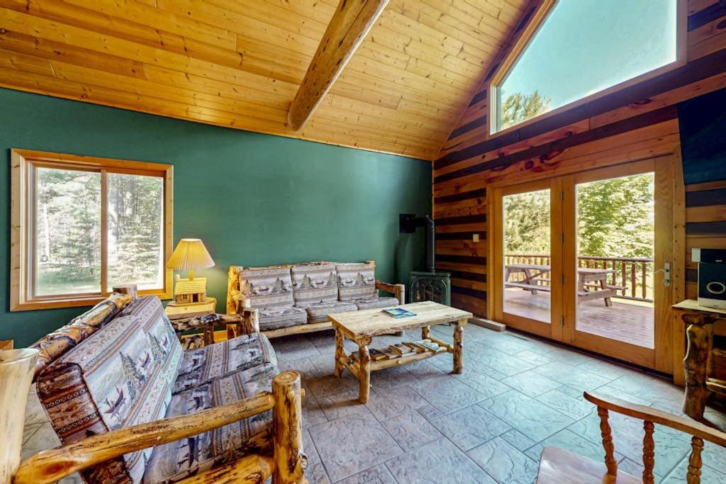 a living room with a couch and a table at Pine Tree House in Mercer