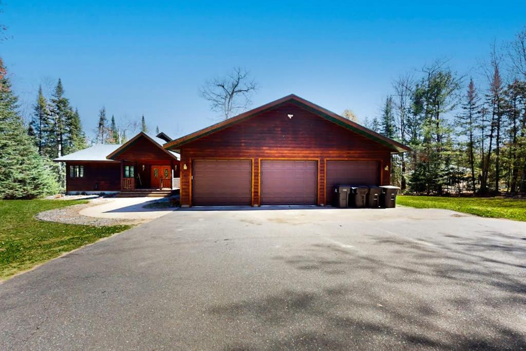 a house with a garage in front of a driveway at Blissful St Germain Retreat in Saint Germain