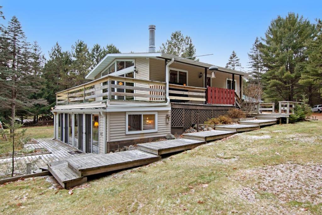 a large house with steps leading up to it at Catfish Lake Home in Eagle River