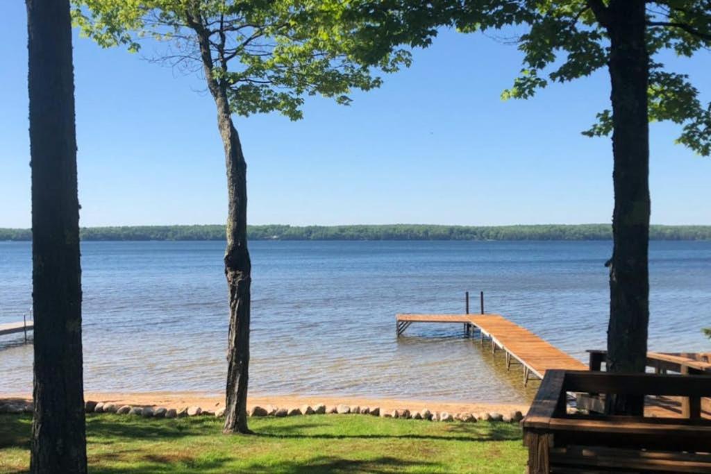 a dock in the middle of a lake with trees at Briar's Hideaway in Phelps