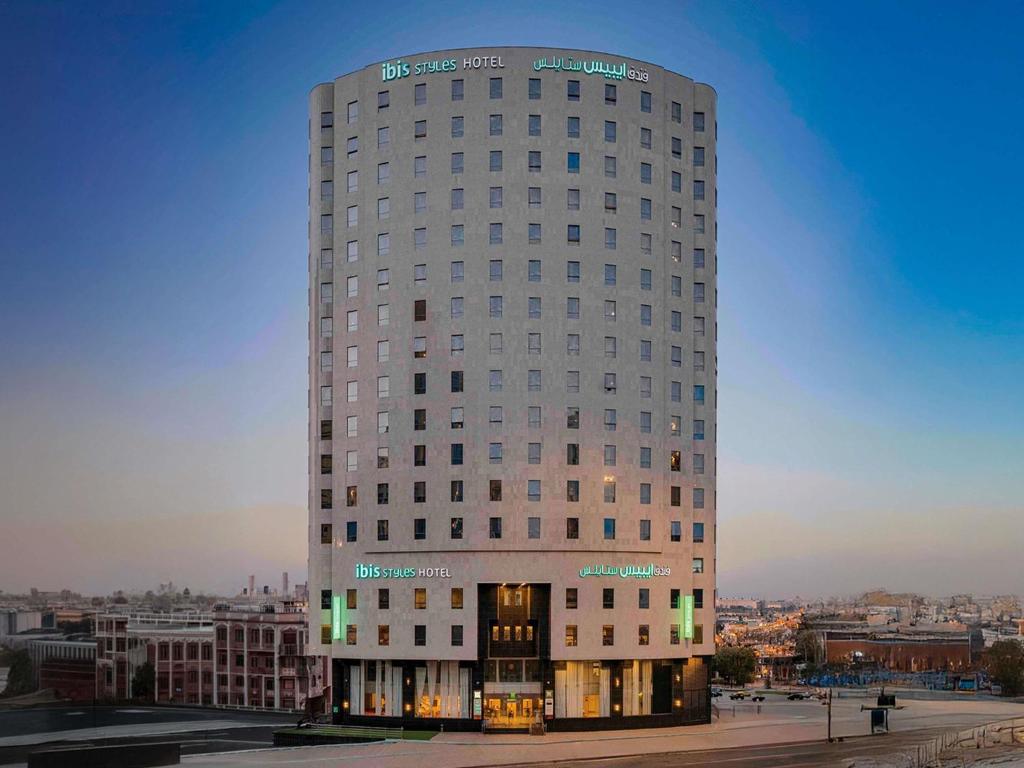 a tall white building with a lot of windows at ibis Styles Makkah in Mecca