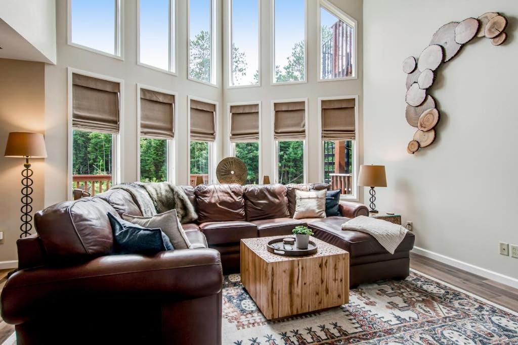 a living room with a leather couch and a table at Copperwood #4 in Eagle River