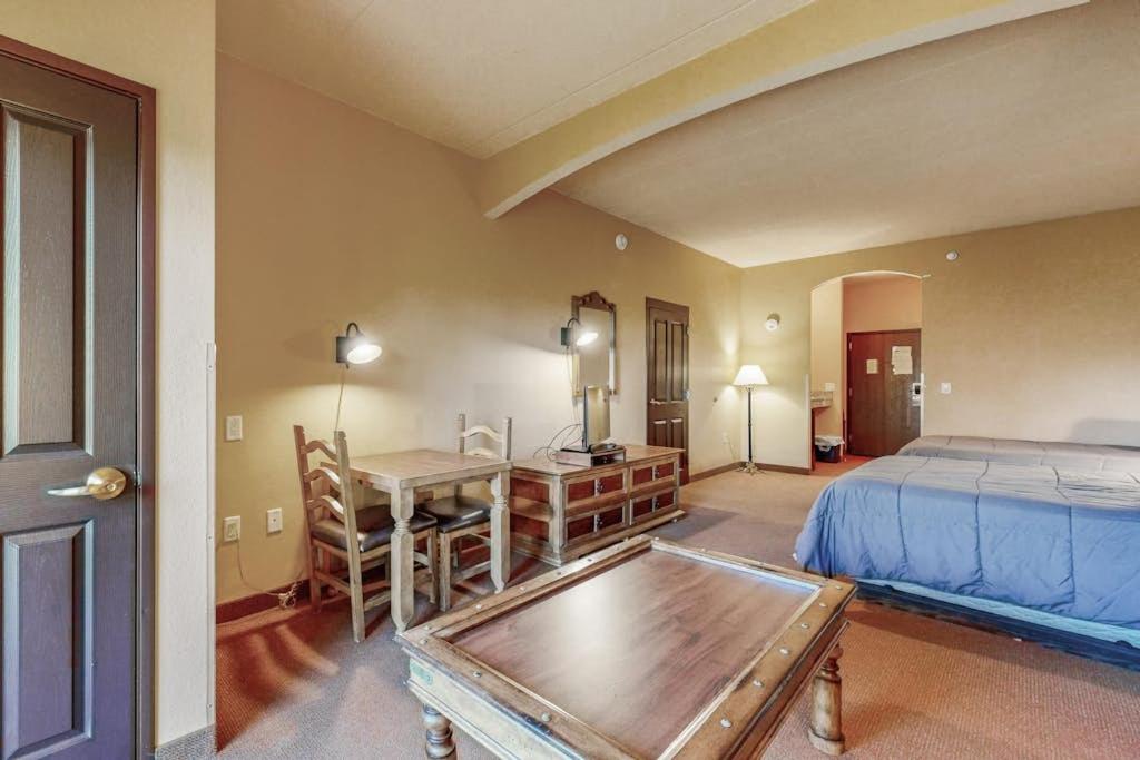a bedroom with a bed and a desk and a table at Chula Vista Condo Unit 2647 in Wisconsin Dells