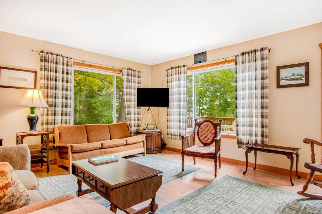 a living room with a couch and a table at Ashton House in Phelps