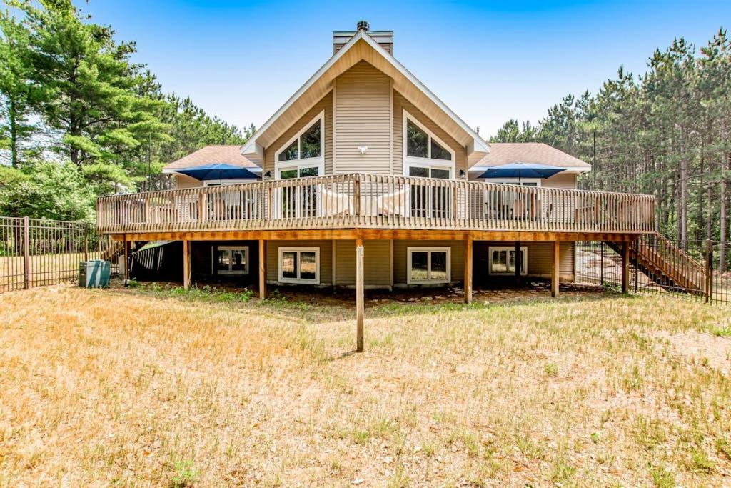 a large house with a large deck on it at Peaceful Pines in New Rome