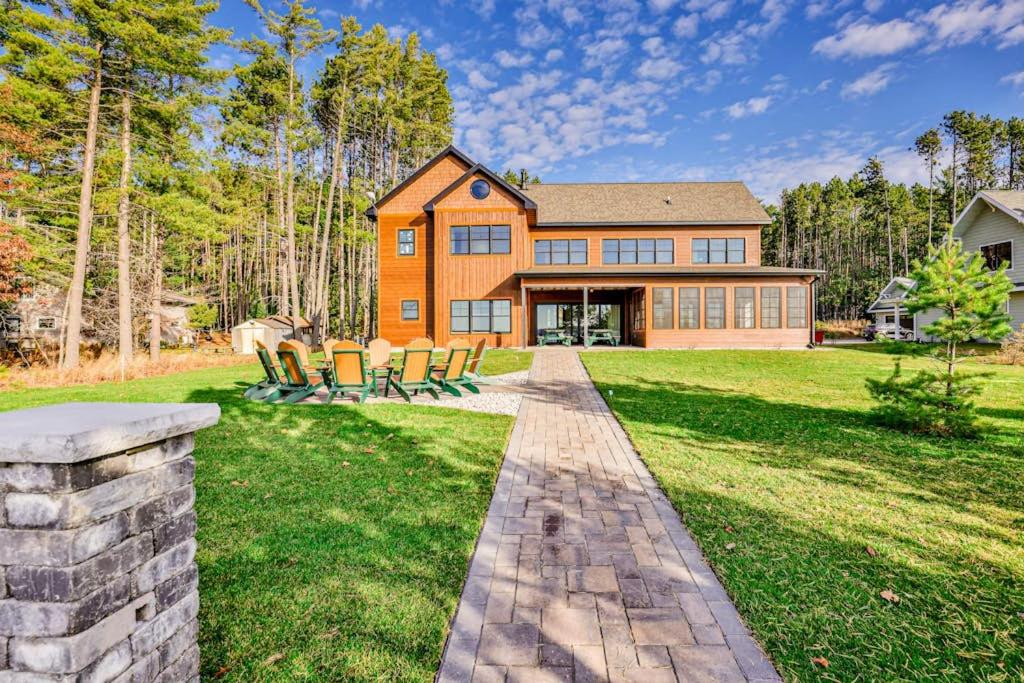 a home with a brick walkway in the yard at Endless Summer in Sayner