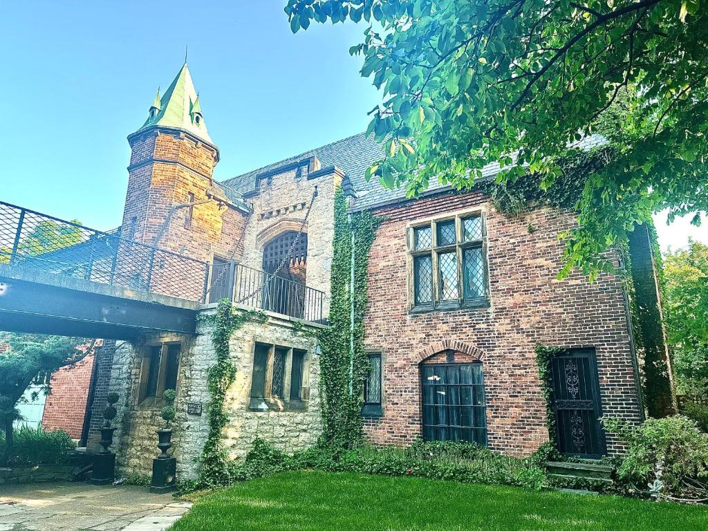 an old brick building with a tower and a cross at The Mayfair Castle in Buffalo