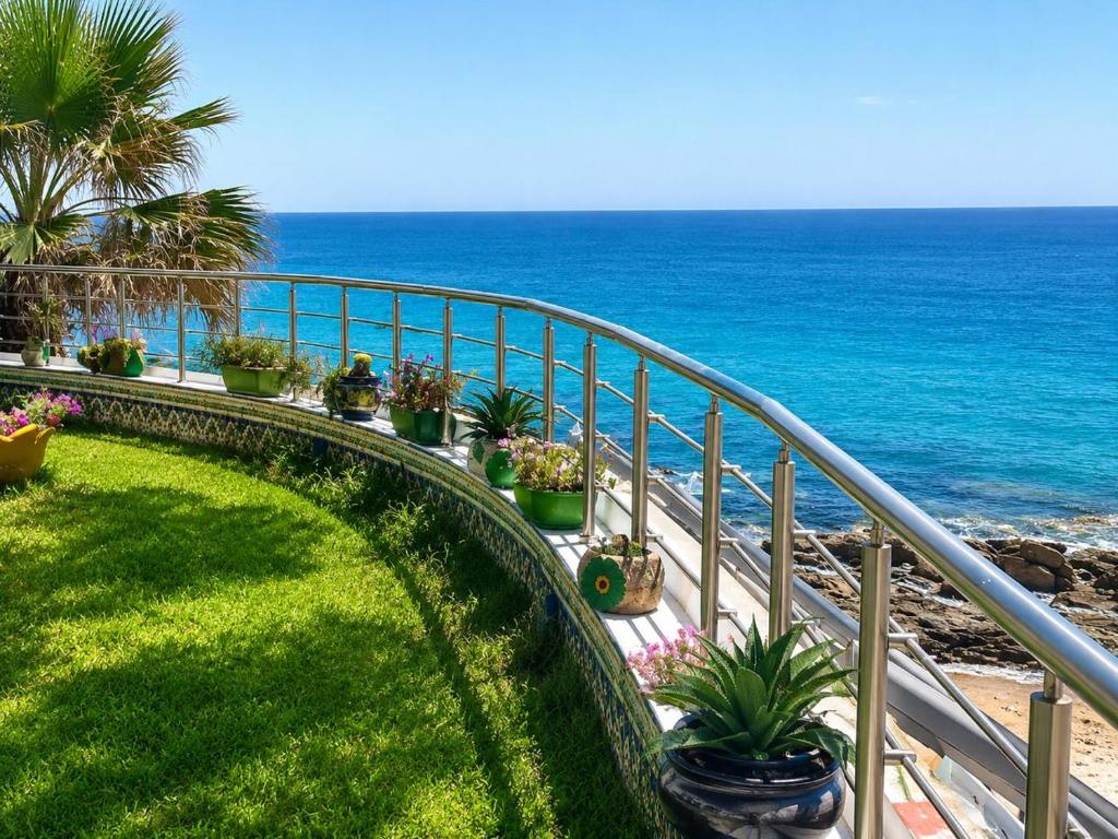 a balcony with a view of the ocean at Seaside Mediterranean Duplex in Kelibia