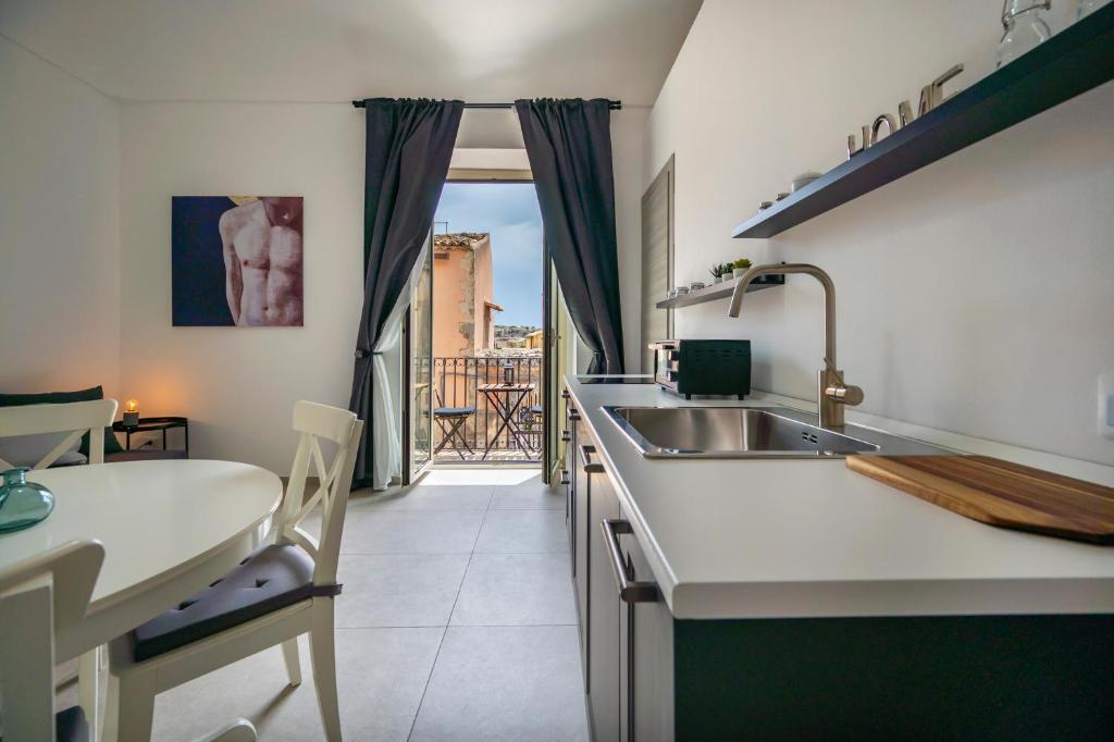 a kitchen with a sink and a counter top at Demetra in Noto