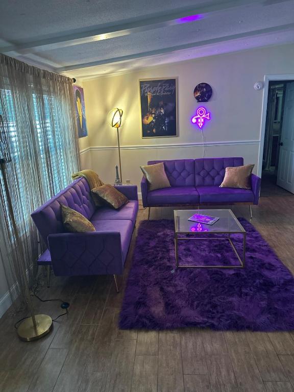 a living room with purple couches and a purple rug at The Get Away Haven in Stockbridge
