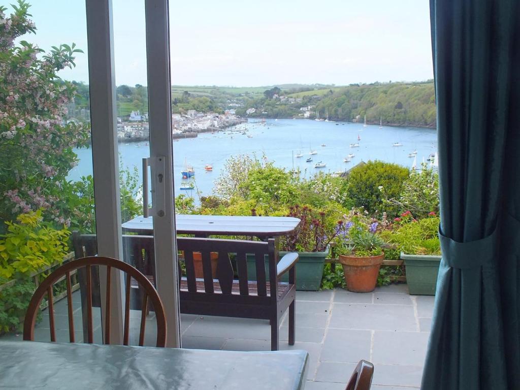 a balcony with a view of a body of water at 3 Bed in Polruan oc-pc052 in Polruan