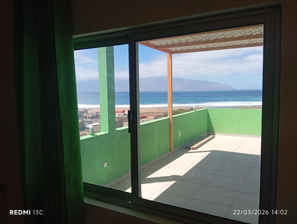 a view of the beach from a room with a window at Casa Chez Zoe in Salamansa